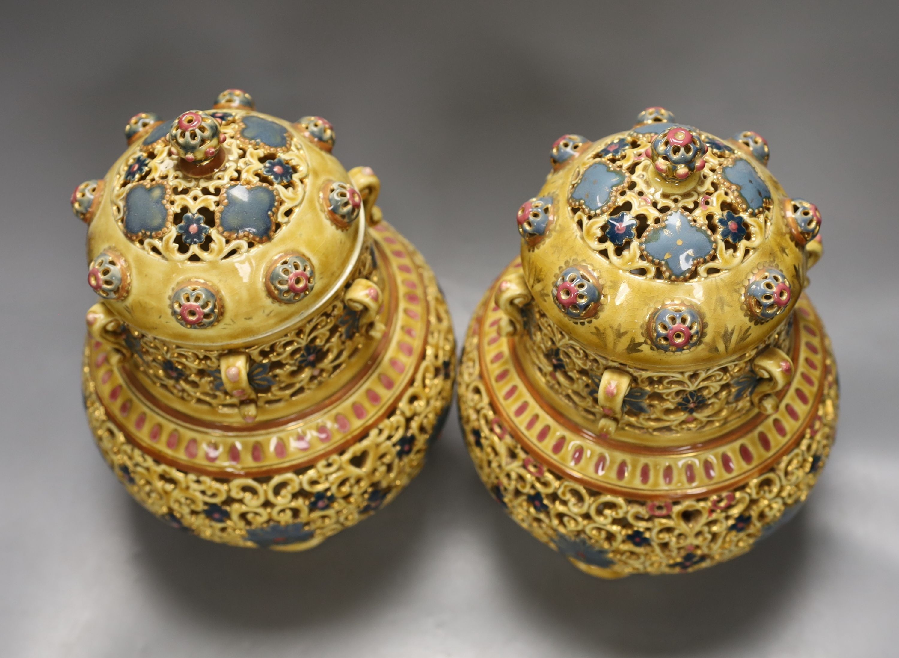 A pair of Zsolnay Pecs Persian inspired vases and covers, 27 cms high.